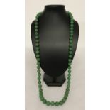 A 34" jade beaded necklace, knotted between each bead.