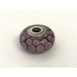 A Pandora pink spotted Murano glass charm bead.