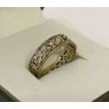 A 9ct gold Celtic style wedding band. Size L.