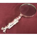 A silver plated novelty handled magnifying glass in the shape of a golf bag with clubs.