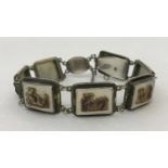 A vintage carved shell 7 panel bracelet with safety chain.