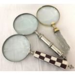 3 large magnifying glasses, one with a chunky faceted glass handle.