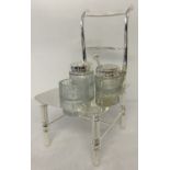 A silver plated and cut glass novelty cruet in the shape of a chair.