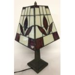 A modern square shaped metal based table lamp with leaded glass shade, shade (a/f).