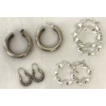 4 pairs of silver and white metal hoop style earrings.