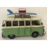 A modern painted tin plate model of a camper van.