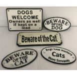 A collection of 5 painted cast iron wall hanging cat and dog plaques.