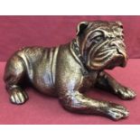 A bronzed cast iron figurine of a Pitbull dog.
