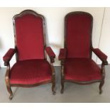 A pair of his and hers vintage wooden high back arm chairs.
