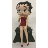 A painted cast iron sitting figurine of Betty Boop.