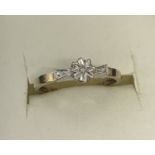 A 9ct gold illusion set diamond solitaire ring.