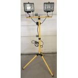 A modern metal framed freestanding set of workshop lights.