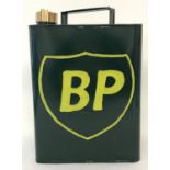 A green and yellow,painted metal, BP 2 gallon petrol can with brass screw top lid.