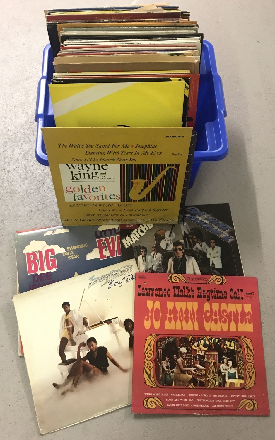 A tub of assorted vintage vinyl records to include Pop, Swing, Country and Comedy.