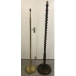 A vintage dark wood barley twist standard lamp together with a more modern brass standard lamps.