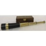 A leather and brass 3 draw telescope contained in a wooden box with brass anchor motif.