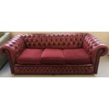 A red leather Chesterfield style 3 seater settee with reupholstered cushions.