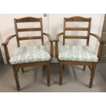 A pair of vintage pine armchairs.