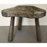 A rustic wooden 3 legged garden stool.