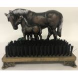 A painted cast metal doorstop and boot brush with painted horse & foal detail.