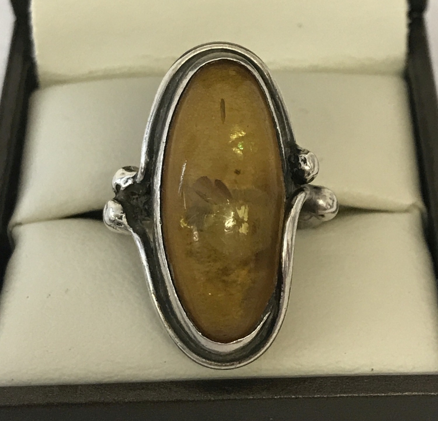 A white metal amber set Art Nouveau style dress ring.