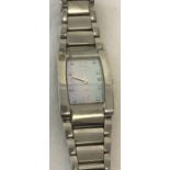 A ladies Tissot stainless steel bracelet watch with mother of pearl face and crystal hour markers.