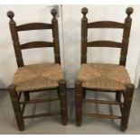 A pair of chunky rush seated kitchen chairs.