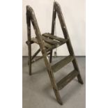 A pair of small vintage wooden folding steps, label reading "A Twyford product".