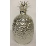 A large silver plated ice bucket in the shape of a pineapple.