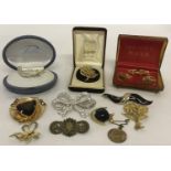 A collection of vintage costume jewellery brooches together with a boxed cufflink and tie pin set.