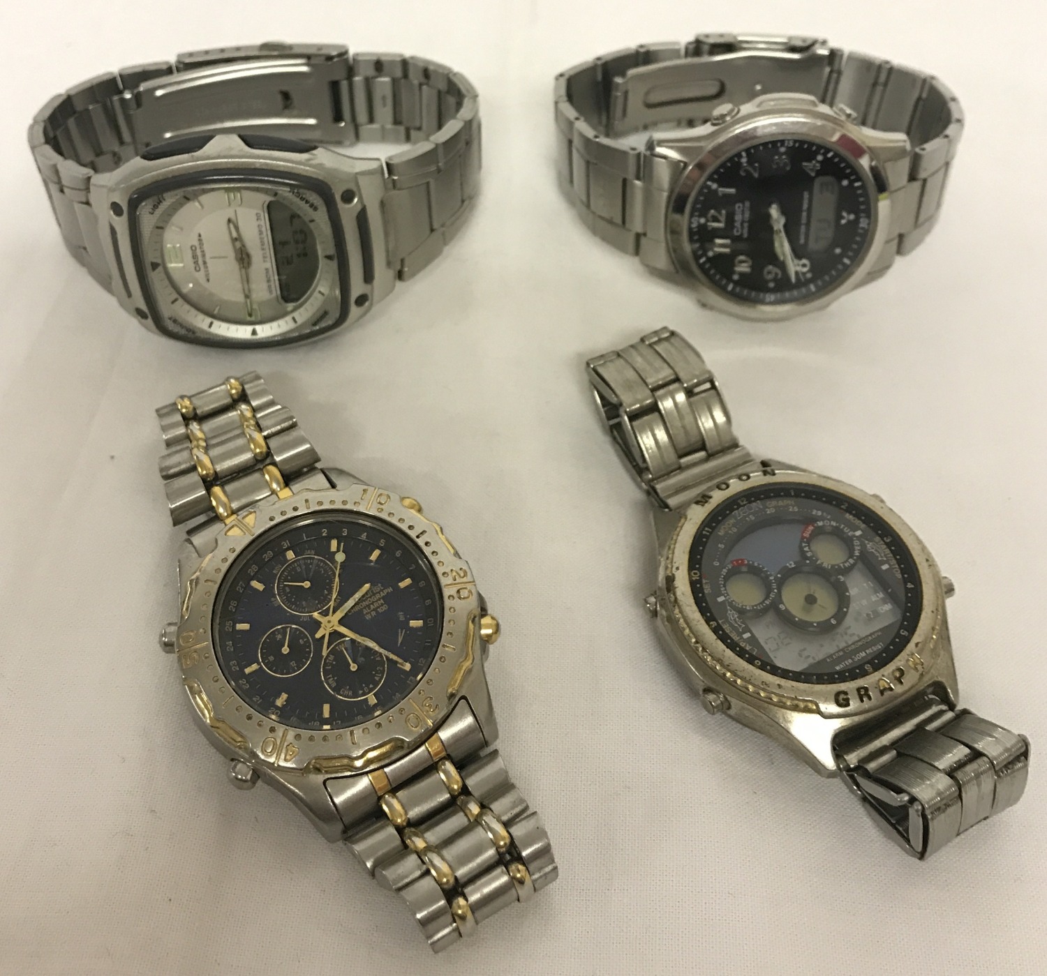 4 men's wristwatches with stainless steel cases and straps.