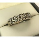 A 9ct gold Greek key design diamond set eternity style ring.