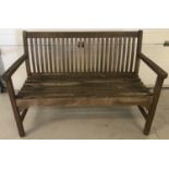 A 3 seater wooden garden bench with slat back detail.