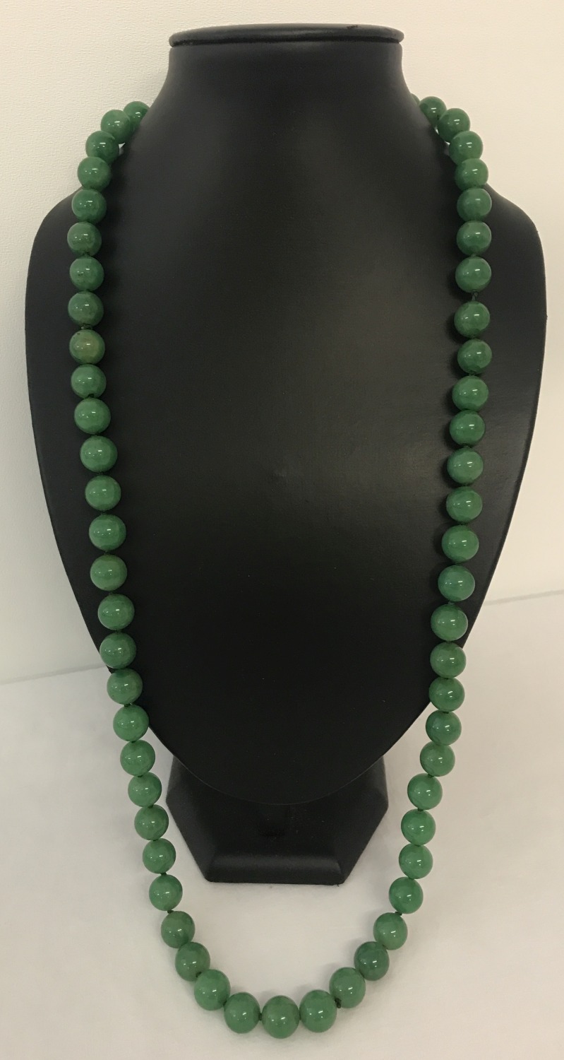 A 32" jade beaded necklace, knotted between each bead.