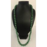 A 32" jade beaded necklace, knotted between each bead.