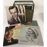 A vintage green coloured record case containing 30 vinyl Frank Sinatra records.