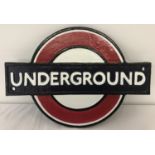 A cast iron London Underground wall hanging plaque, painted in red, white, blue and black.