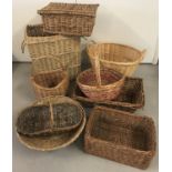 A collection of 9 assorted wicker baskets, to include laundry, picnic, shopping and display.