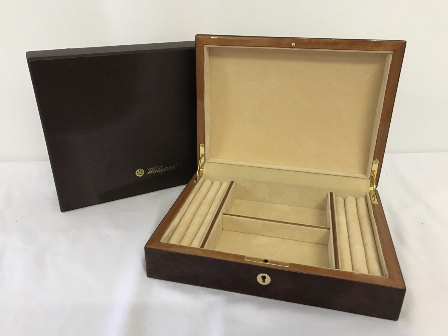 A new boxed red Birdseye maple jewellery box by Walwood.