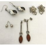 4 pairs of silver and white metal earrings.