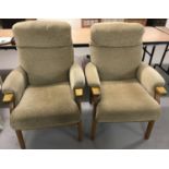 A pair of beige velour Parker Knoll style armchairs with wooden frames.