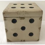 A modern wooden box in the shape of a dice with brown painted interior.