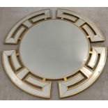 A large round Oriental themed mirror with gilt wooden frame and bevel edged glass.