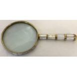 A magnifying glass with mother of pearl panelled detail to handle and glass surround.