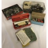 A collection of vintage sewing machine parts and accessories.
