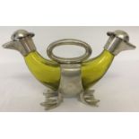 A yellow glass double decanter in the shape of ducks.