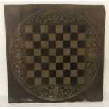 A decorative wooden chess board with floral design borders.