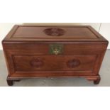 An oriental camphor wood blanket chest with carved Fu Bat Chinese symbol to front and top.