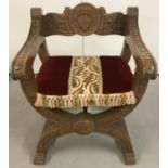 A heavy X-frame carved wooden chair.