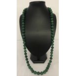 A 34" jade beaded necklace, knotted between each bead.